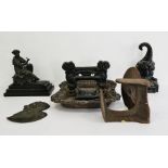 19th century black wrought iron boot and shoe scraper, a wrought iron weighted doorstop, a spelter