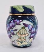 Moorcroft miniature enamel vase and cover, allover decoration of spring flowers including