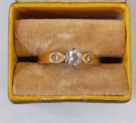 18ct gold solitaire diamond ring, claw set, having two small diamonds to the shoulders  Condition