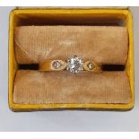 18ct gold solitaire diamond ring, claw set, having two small diamonds to the shoulders  Condition