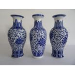 Pair Chinese porcelain baluster vases with underglaze blue decoration of flowerheads, on a scrolling