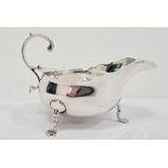 Victorian silver sauce-boat having everted rim, foliate decorated free C-scroll handle, on three