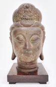 Bronze bust of a Buddha, on square wooden plinth base, 33cm high overall