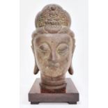 Bronze bust of a Buddha, on square wooden plinth base, 33cm high overall