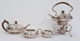 George V silver tea set, each piece oblate with reeded band, the teapot with pearwood finial and