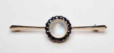 Gold-coloured metal, sapphire cluster and moonstone brooch centred by single cabochon moonstone