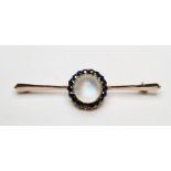 Gold-coloured metal, sapphire cluster and moonstone brooch centred by single cabochon moonstone