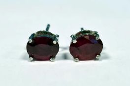 Pair of treated ruby studs in silver, boxed