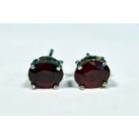 Pair of treated ruby studs in silver, boxed