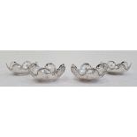 Set of four George V silver pierced bonbon dishes, the sides with six pierced flowerhead roundels,