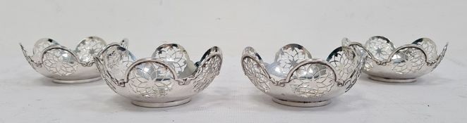 Set of four George V silver pierced bonbon dishes, the sides with six pierced flowerhead roundels,