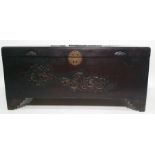 20th century Eastern coffer with carved dragon decoration to the lid, raised on bracket feet