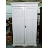 White painted two-door compactum wardrobe with ogee moulded pediment, two panelled doors enclosing