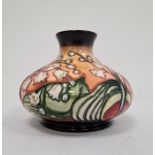 Moorcroft pottery vase, squat baluster-shape with lily of the valley decoration, on an ochre ground,