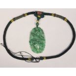 Chinese carved green jade pendant, oval and decorated with fawn, bird, lotus leaves, etc, 8cm high