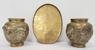 Pair of Chinese brass vases embossed with dragons autour, ovoid, Chinese character mark to base,