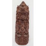 Indian carved hardwood obelisk of deities and grotesque mask, 32cm high