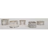 Five assorted silver napkin rings, various dates and makers to include Emile Viner, Sheffield,