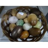 Collection of onyx and carved wooden eggs together with an oak carved hanging wall cupboard