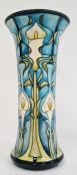 William Moorcroft vase in cream, blue and greens with flared rim, marked ‘Moorcroft’ to base and