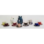 Poole pottery cup, a Dartmouth pottery blue glazed fish guggle jug, a miniature toby jug, part