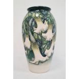 Moorcroft pottery vase, tall ovoid and decorated with white fuchsia on a blue and cream ground,