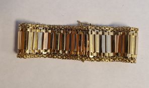 18ct gold three-colour bracelet of flexible bar-pattern with multi-coloured flattened bars to the