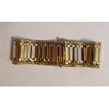 18ct gold three-colour bracelet of flexible bar-pattern with multi-coloured flattened bars to the