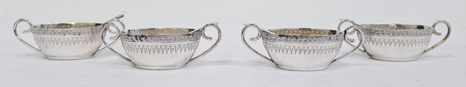 Set of four Victorian silver salts of oval form with engraving to the body, scroll handles, with