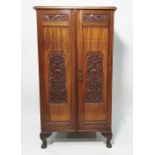 Victorian walnut two-door cabinet  with moulded decoration, the doors opening to reveal linen-type