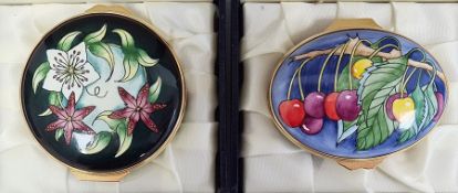 Moorcroft enamel patch box, oval and decorated with cherries on a blue ground, 6cm wide, boxed and
