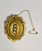 Victorian yellow gold and seedpearl shaped oval brooch centred by three pearls on stepped base,