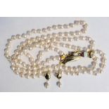 18ct gold baroque pearl two-strand necklace, 70cm long having stylised foliate 18ct gold white and
