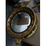 Convex wall mirror surmounted with eagle, sprayed gold with ball decoration and another circular