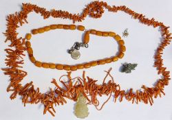 Amber-coloured bead necklace, a branch coral necklace, a small Chinese carved jade pendant and a