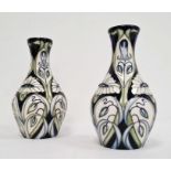 Pair of Moorcroft pottery vases, each ovoid with slender neck, tube-lined decoration of convulvous