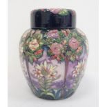 Moorcroft ginger jar decorated on a purple ground with white flowers and trees, marked to base '