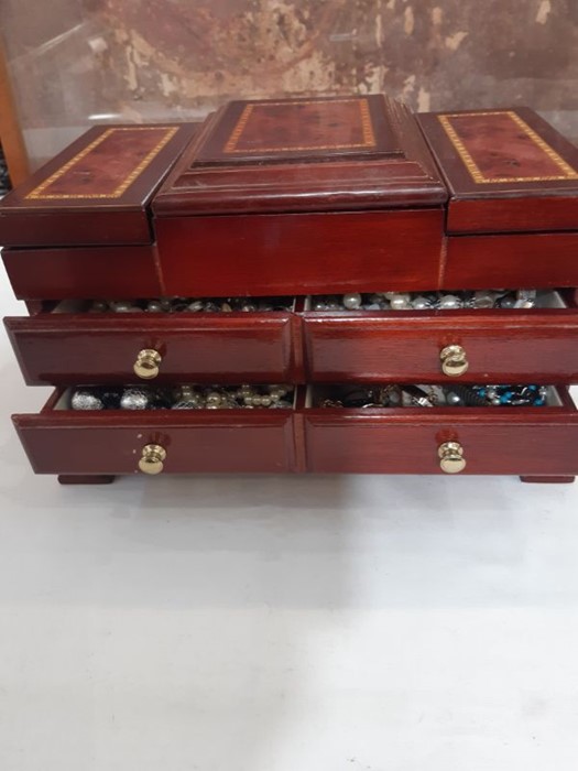 Quantity of costume jewellery and watches in folding jewellery chest