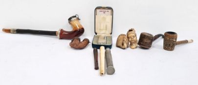 Assorted pipes including one in the form of  Moor's head, one in the form of swan and a Dunhill