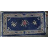 Pair of Chinese blue ground carpets, foliate decoration, 132cm x 75cm (2)