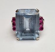 Pale blue paste and ruby ring set centre rectangular step-cut paste stone (20mm x 14mm) flanked by