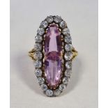 Gold-coloured pink stone, probably tourmaline, and diamond dress ring, of marquise form set with