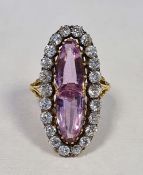 Gold-coloured pink stone, probably tourmaline, and diamond dress ring, of marquise form set with