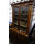 Edwardian walnut bookcase with two glazed doors enclosing shelves, above two drawers and two