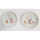 Pair antique Chinese porcelain saucers, each painted with two figures beside tree and sheep, 13cm