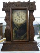 Late 19th/early 20th century American mantel clock in carved Art Deco style oak case, the movement