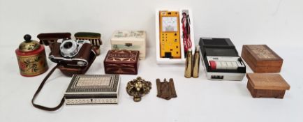 A collection of various cameras, a voltmeter, various boxes and brassware and coloured printed