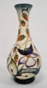 Moorcroft pottery baluster vase by R Bishop, cream ground with allover periwinkle decoration,