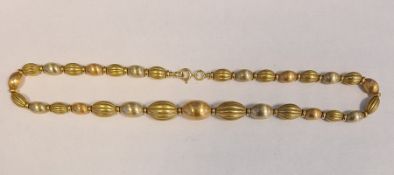 18ct gold and multi-colour graduated oval bead necklace, some beads ribbed and alternating with