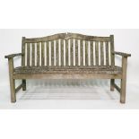 Very weathered garden bench, slat seats and curved back rail